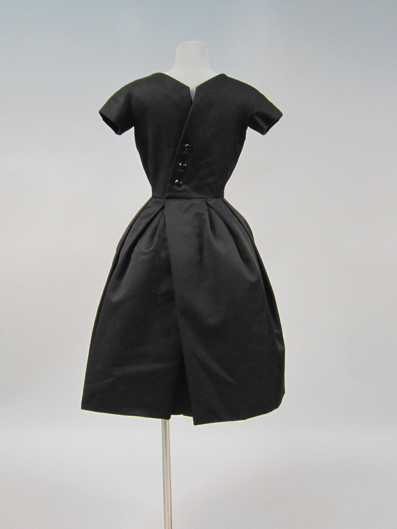 Image of Woman's black alpaca wool cocktail dress with underskirt, 1956
